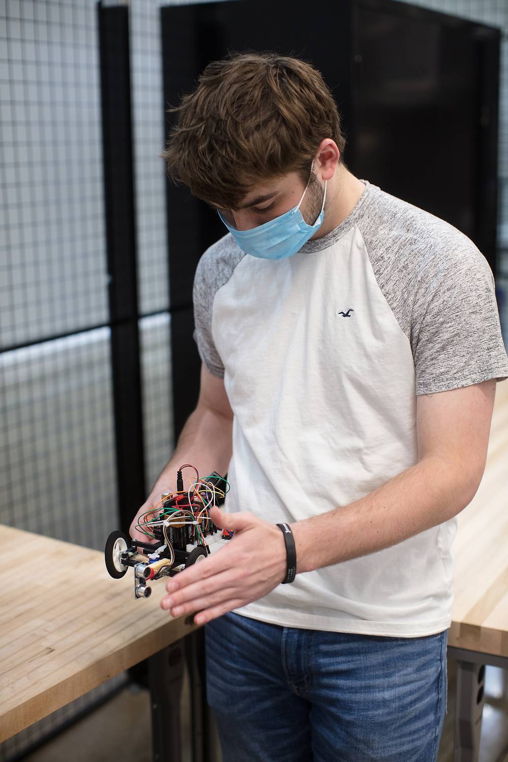Student looks at robot